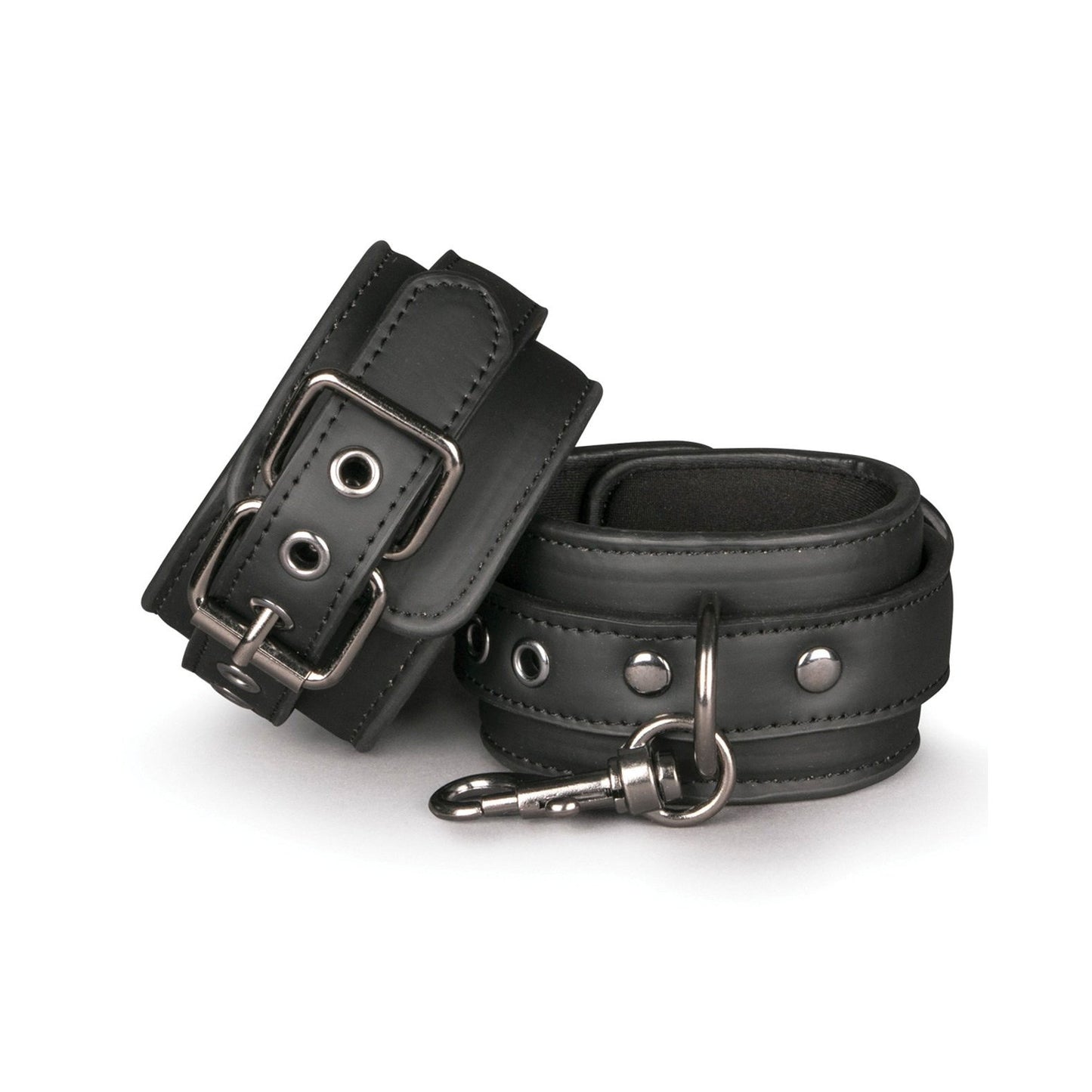 The Easy Toys Faux Leather Handcuffs feature two black leather cuffs with silver buckles, D-rings, and a connecting metal clip. Padded for comfort and secure attachment, these adjustable bondage restraints are set on a plain white background for an ideal fit. Brand: Easy Toys.