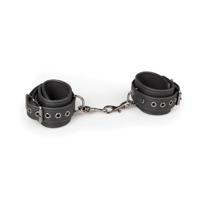 Easy Toys Faux Leather Handcuffs feature black faux leather with adjustable cuffs connected by a short chain and metal clasps. Each cuff includes silver eyelets and buckles for customization, set against a plain white background.