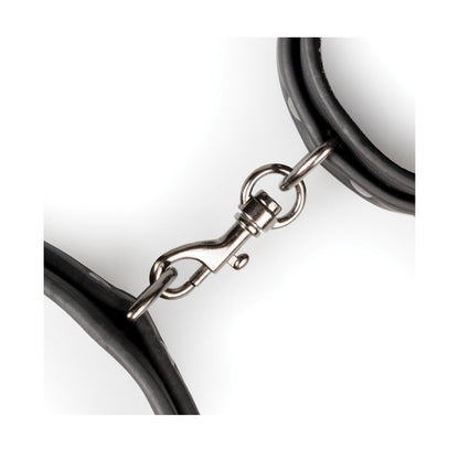 Close-up of the Easy Toys Thigh & Wrist Cuff Set by Easy Toys, featuring a faux leather construction with a sleek black rubber finish and metal swivel snap hook, displayed against a white background. The adjustable design ensures secure fastening at both ends.