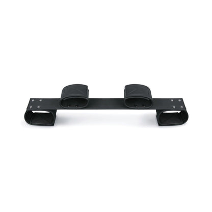 The Easy Toys Wrist & Ankle Bondage Bar, by Easy Toys, is shown against a white background. It features black metal with two curved ends and rectangular mounting pads, designed for securing equipment, reminiscent of a sleek bondage bar used with faux leather cuffs in BDSM contexts.