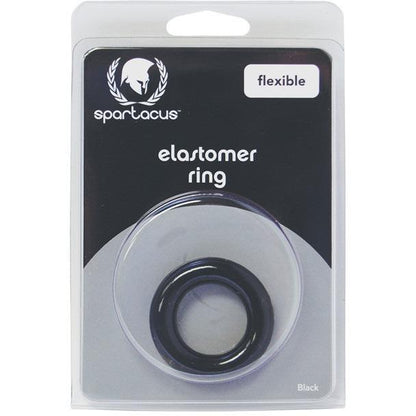 The Elastomer Relaxed Fit Cock Ring by Spartacus is visible through a clear plastic section of its packaging. This sleek black rings package highlights the product type and brand, promoting stronger erections and long-lasting stamina.