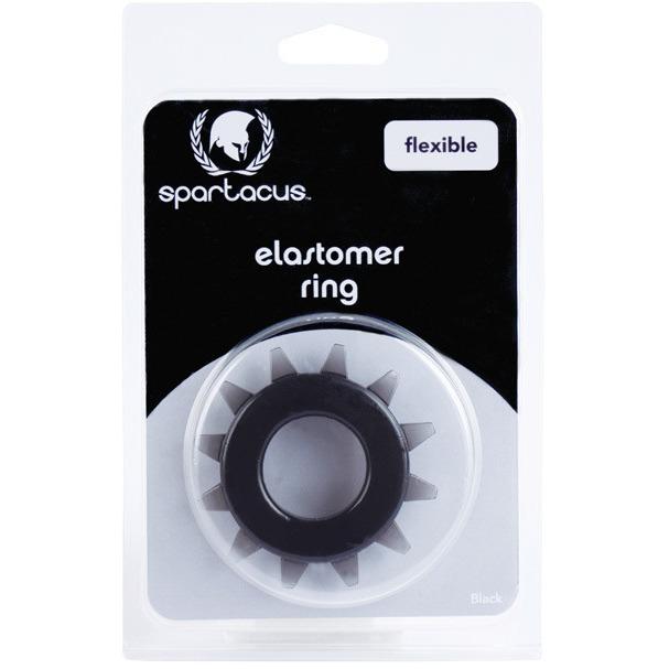 The Spartacus Elastomer Stud Cock Ring features a black, circular gear-like design made from body-safe elastomer, labeled as flexible. Packaged simply with clear plastic and a black and white label, its designed for effective erection enhancement.