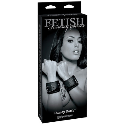 The Fetish Fantasy Limited Edition Cumfy Cuffs box features a confident person wearing bondage cuffs, depicted in black and white, on the front, highlighting Pipedreams innovative design.