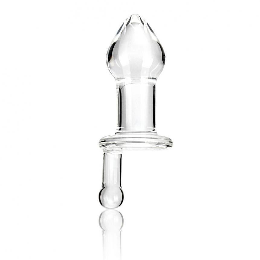The Gläs 5 Juicer Butt Plug, a hand-made clear glass piece with a bulbous top and cylindrical base, stands upright on a white background. Its smooth, reflective surface enhances temperature play, showcasing the allure of its transparent material.
