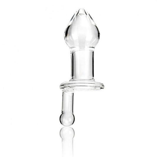 The Gläs 5 Juicer Butt Plug, a hand-made clear glass piece with a bulbous top and cylindrical base, stands upright on a white background. Its smooth, reflective surface enhances temperature play, showcasing the allure of its transparent material.