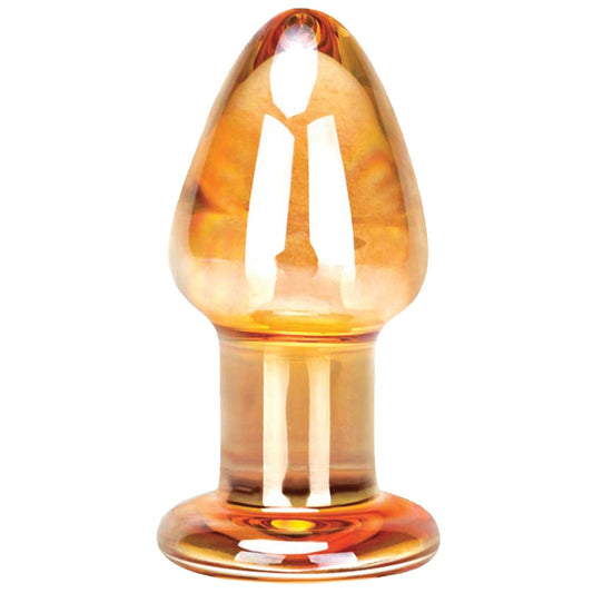 The Gläs Over Easy Butt Plug, a hand-blown translucent amber glass sculpture by Gläs, features a tapered top and wide base that elegantly reflects light.