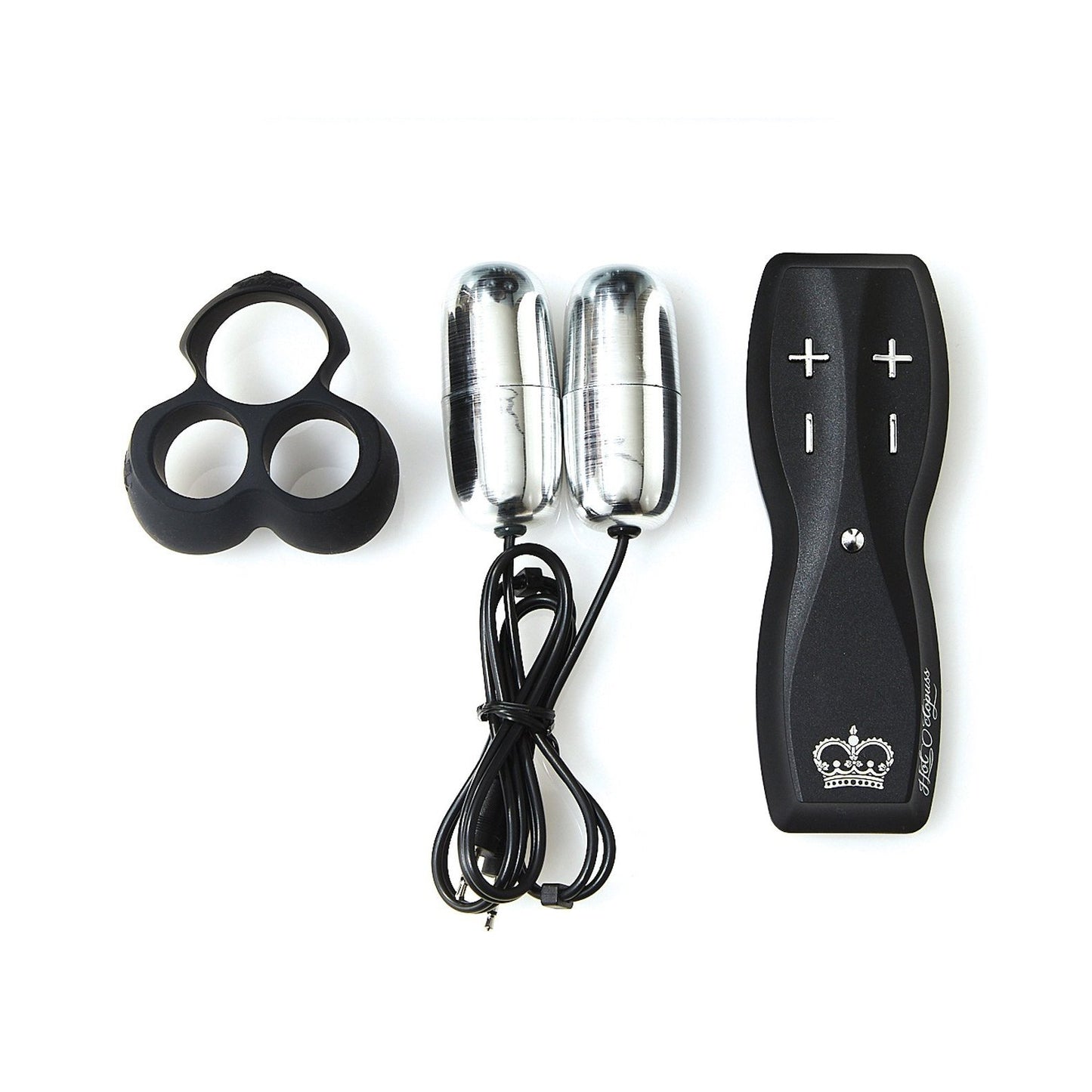 An image of the Hot Octopuss Jett Remote Guybrator, a black device with +/- buttons and Treble and Bass Technology. It includes two metallic capsules like bullet vibrators and a black silicone ring with three circular openings.