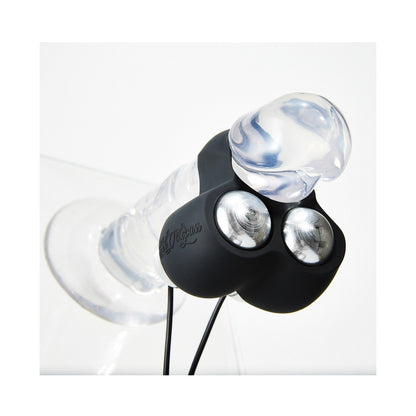 The Hot Octopuss Jett Remote Guybrator is a transparent, jelly-like object with a bulbous tip attached to a black device featuring Treble and Bass Technology, small reflective lights, and wires. It sits on a flat surface, possibly on display, highlighting its innovative design for an engaging experience.
