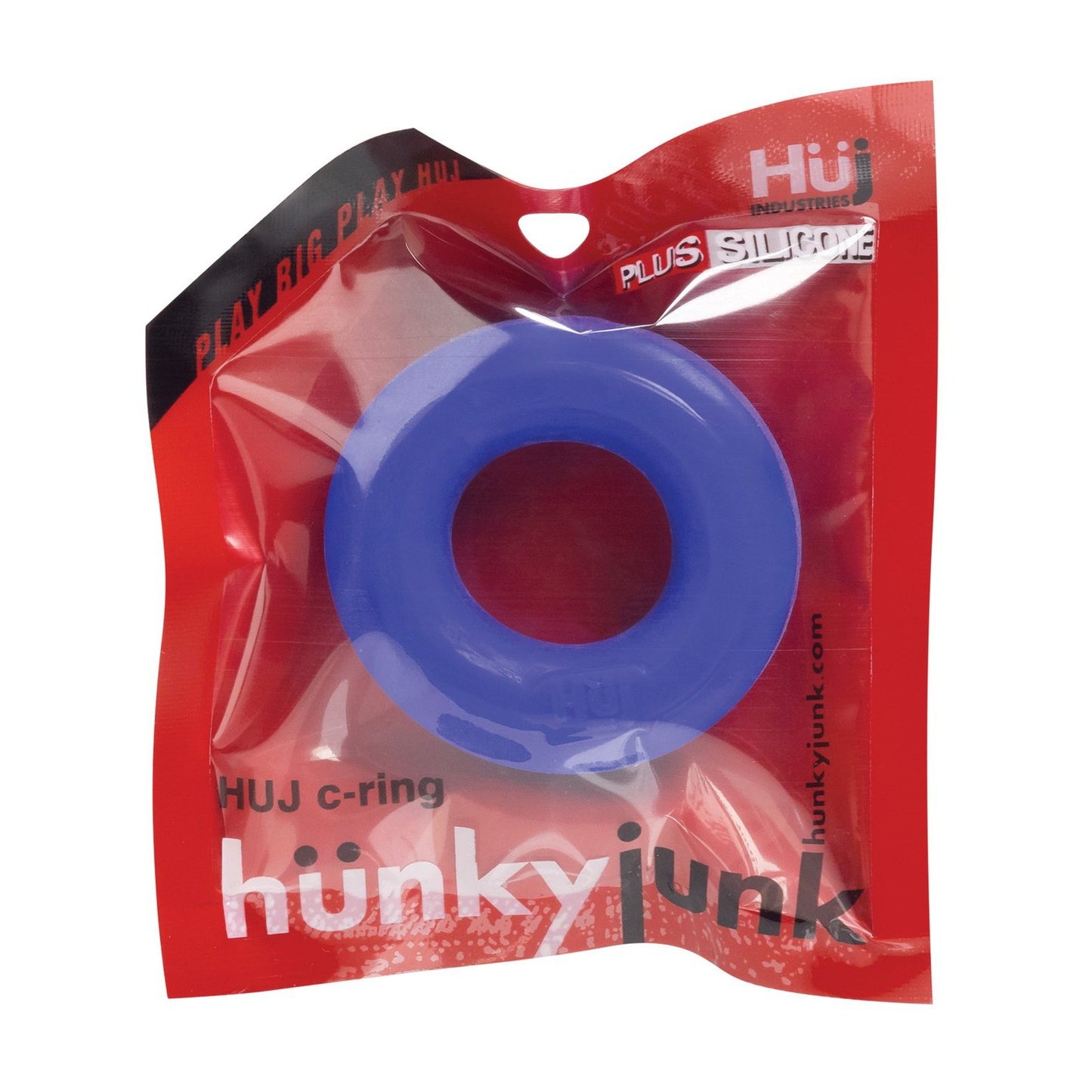 The image showcases a blue Hunky Junk C Ring from the Singles collection in a red and transparent plastic package, labeled hunkyjunk and HUJ c-ring by Hunky Junk. This silicone cock ring features playful packaging with creative branding text.