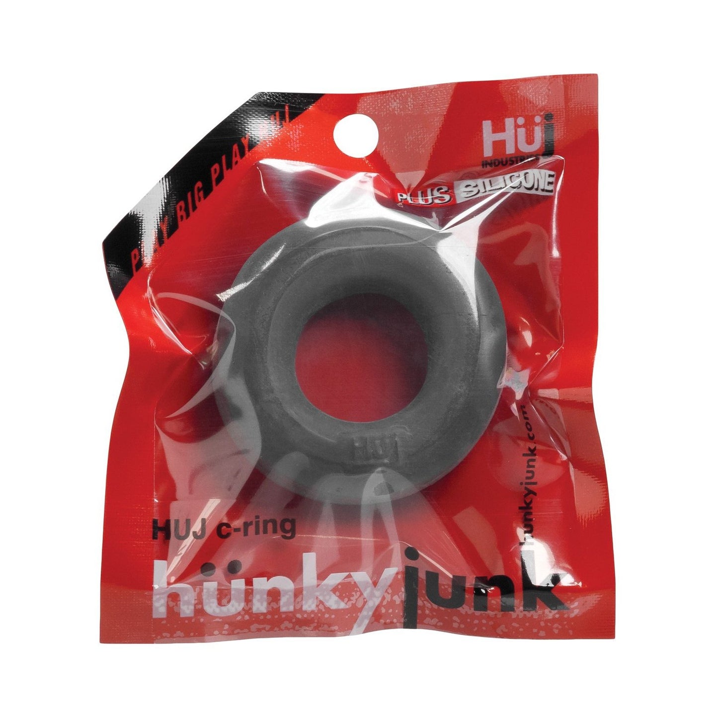 The image shows a red-clear package with a black cock ring labeled Hunky Junk C Ring - Singles by Hunky Junk, highlighting the PLUS SILICONE blend on top.