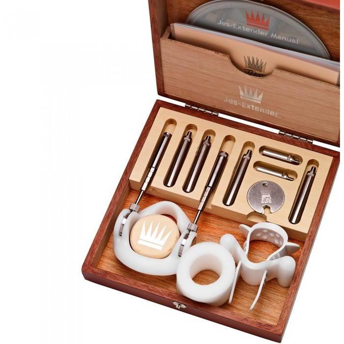 A wooden box displaying the Jes Extender Original Standard Penis Enlarger Kit by Jes, containing metallic rods, components, two circular silicone pieces, and an instruction manual. The open box showcases all parts neatly arranged inside.
