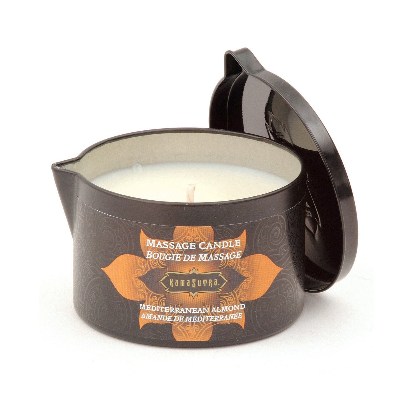 A black Kama Sutra Ignite Massage Candle by Karma Sutra, in a container with an ornate orange and brown label, features the Coconut Pineapple scent and promises a moisturizing formula. The partially open lid reveals white wax inside, inviting a sensual massage experience.
