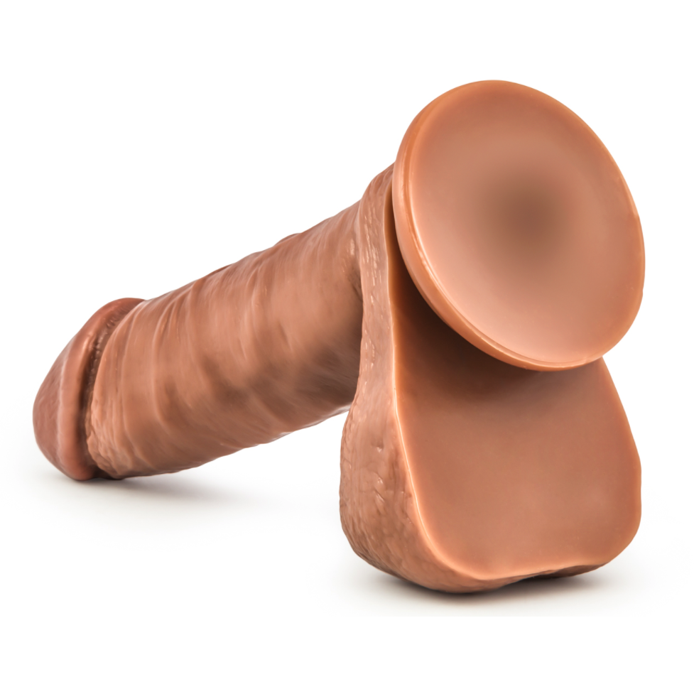 The Matador by Blush Novelties is a hyper-realistic 6.25 silicone dildo with lifelike texture, anatomical design, cylindrical shape, natural skin tone, and detailed features. It includes a secure rounded base and versatile suction cup for varied placement.