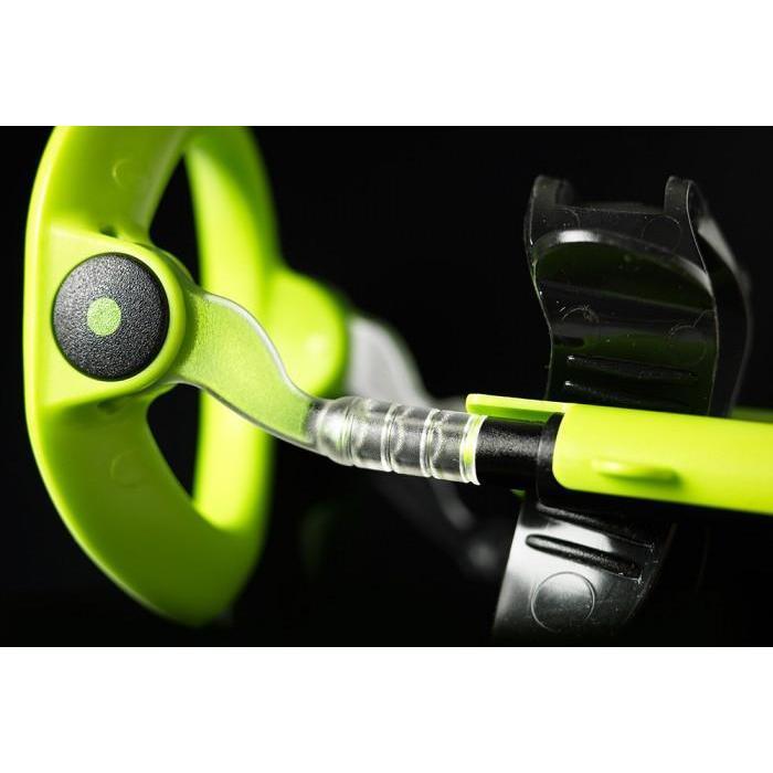 Close-up of a green and black fishing reel with detailed focus on the handle and spool against a dark background, evoking the precision associated with the Male Edge Extra Penis Enlarger Kit by Male Edge.
