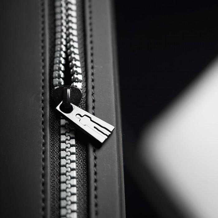 In a detailed close-up, the black zipper with its metal pull tag resembles the precision of a Male Edge Extra Penis Enlarger Kit. Partially open, the zippers teeth contrast with the dark fabric background, as lighting casts subtle shadows to enhance its texture.