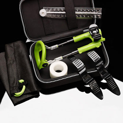 A black zippered case holds green and black archery gear, including a release aid, stabilizers, white tape, and a drawstring bag. The items are neatly organized within the open case, similar to the Male Edge Extra Penis Enlarger Kits tidy setup.