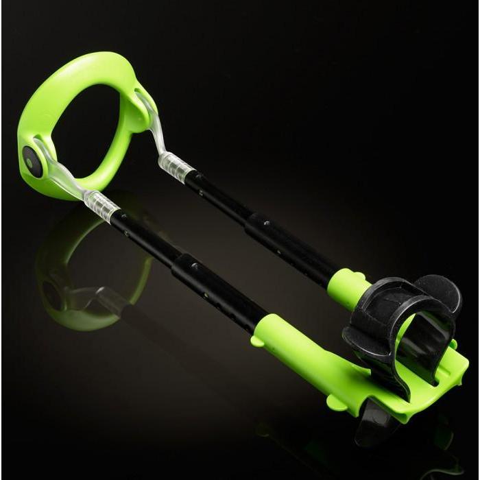 A green and black handheld grabber tool, similar to a sleek part from the Male Edge Extra Penis Enlarger Kit by Male Edge, includes a handle and gripping claw against a dark background.