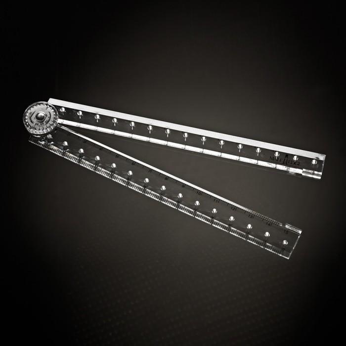 A Male Edge Extra Penis Enlarger Kit protractor with two clear rulers forms a semi-circular shape on a dark background, featuring measurement markings and a circular pivot point, symbolizing the precision of the Male Edge system.