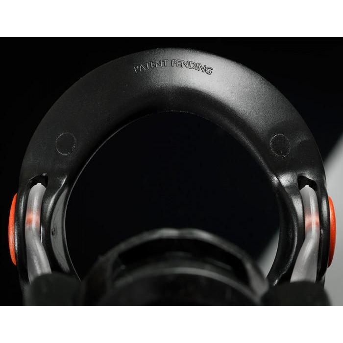 Close-up of a black circular device with PATENT PENDING engraved, highlighted in red and metallic accents. The Male Edge Pro Penis Enlarger Kit from Male Edge showcases innovative traction technology against a dark backdrop.