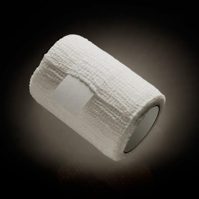 A roll of white medical gauze is shown against a dark background, its texture highlighted like the precision in products such as the Male Edge Pro Penis Enlarger Kit by Male Edge, which employs advanced traction technology for optimal results.