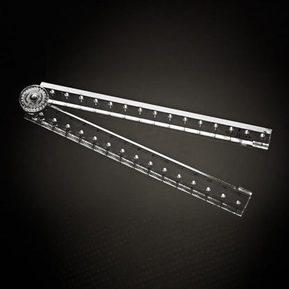 A clear, adjustable protractor with a rotary knob is set against a dark backdrop. Like the precision of the Male Edge Pro Penis Enlarger Kit by Male Edge, it features two rulers with marked measurements that form an angle, excelling in accurately drawing and measuring angles.