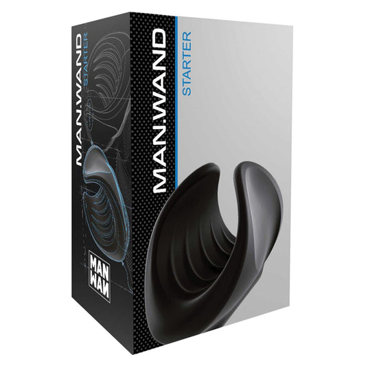 The image features the Man Wand Starter box from Adams Toy Box, displaying a sleek black object as a compact cock pleaser. The blue and white packaging text highlights its 10 vibration modes and 100% liquid silicone construction on a black backdrop.