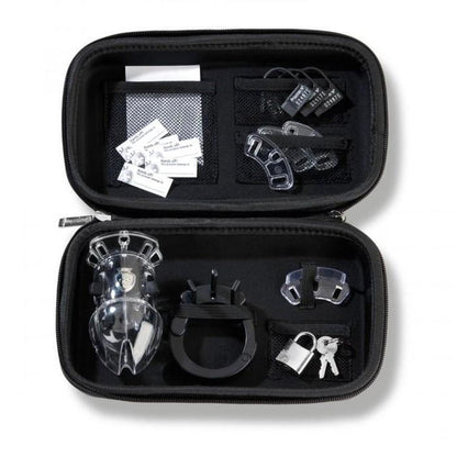 A black zippered case opens to display its contents, including a transparent plastic device, various small black and clear attachments, a metal lock with keys, and labeled tags—all neatly organized alongside the discreet Mystim Pubic Enemy #2 Cock Cage in dedicated compartments.