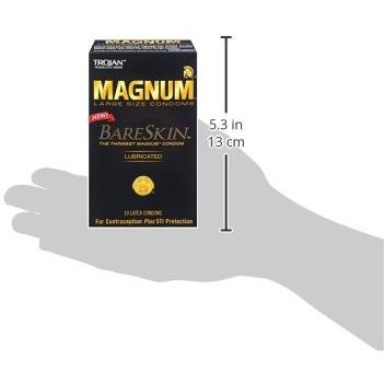 A hand holds a black box of New Trojan Magnum Bareskin Condoms (Box of 10). The package features lubricated latex condoms and highlights contraception and STI protection, with dimensions shown as 5.3 inches (13 cm) tall.