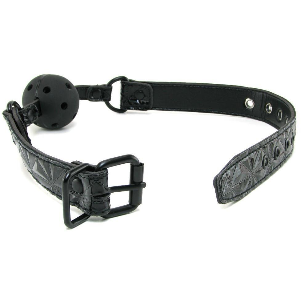 The NS Novelties Sinful Ball Gag is displayed against a white background, featuring a black leather design with a textured strap and buckle. It includes a black perforated ball and sturdy metal rings for fastening, all from the NS Novelties brand, highlighting its sleek, exquisite finish.