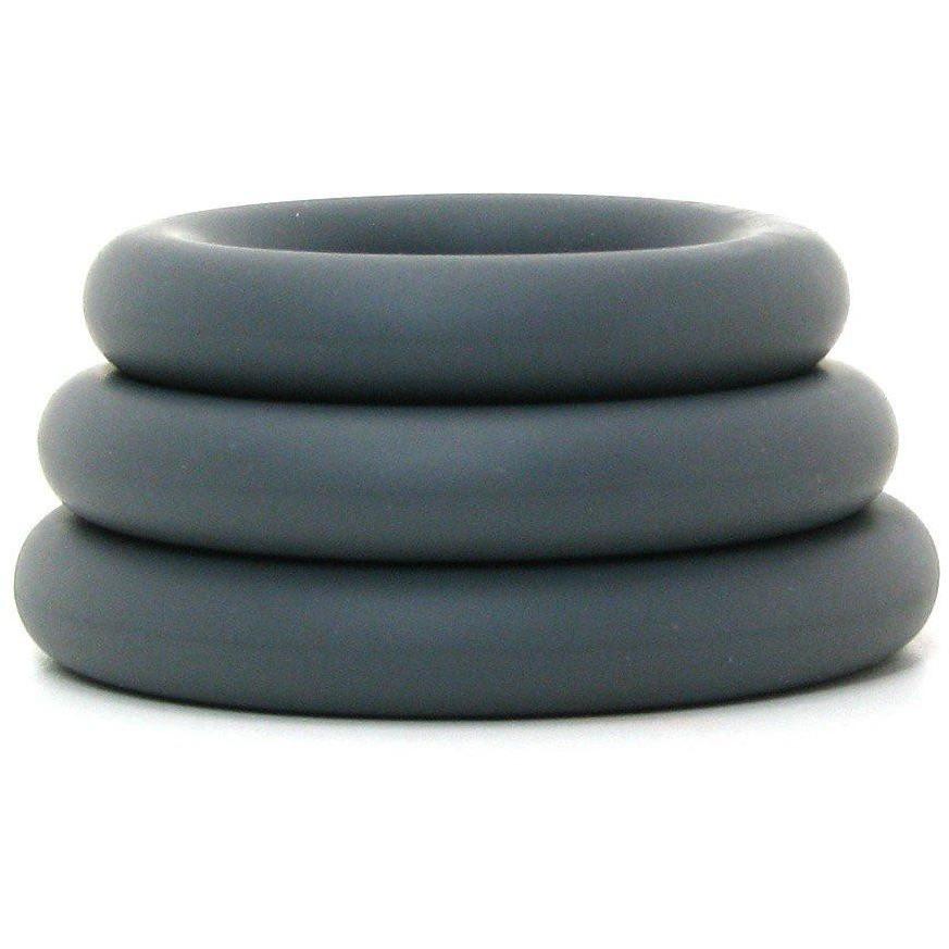 A tapering tower of Adams Toy Box OptiMale C Ring Kit Thick cock rings in dark gray super stretchy silicone, featuring three matte-finished rings of varying sizes for long-lasting erections, set against a white background.