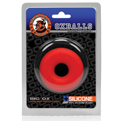 Packaging of a red silicone ring labeled Oxballs Big Ox Cockring against a black and gray background featuring the Oxballs logo and tagline Shockingly Superior, showcasing their superior craftsmanship in cock rings.