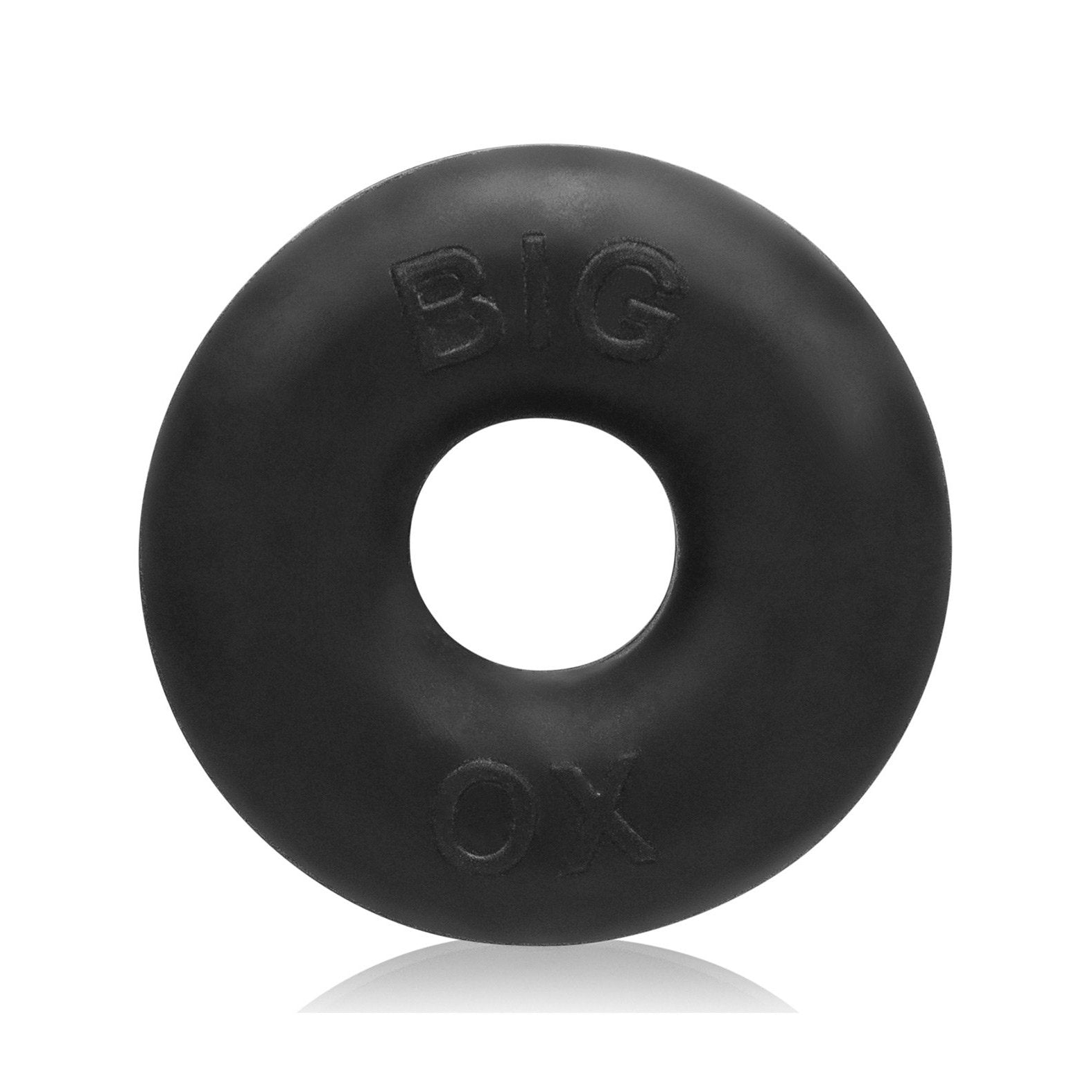A black, circular Oxballs Big Ox Cockring by Oxballs features a smooth texture and BIG OX embossed on its glossy surface, casting a subtle shadow on the white background.
