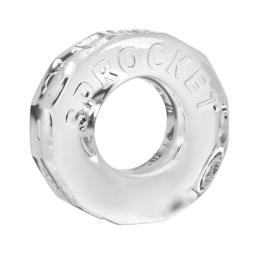 The Oxballs Sprocket Cockring, by Oxballs, is a clear glass octagonal item with a central hole, resembling a large nut or washer. It features the embossed word SPROCKET on its surface and boasts durability similar to body-safe TPR material.