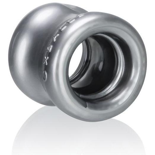 The Oxballs Squeeze Ball Stretcher by Oxballs is a metallic, cylindrical object with a hollow center and glossy finish. Its ergonomic, ring-like design includes a smooth, reflective surface and resembles a mechanical component or decorative piece crafted from Flex-TPR for flexibility.