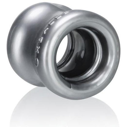 The Oxballs Squeeze Ball Stretcher by Oxballs is a metallic, cylindrical object with a hollow center and glossy finish. Its ergonomic, ring-like design includes a smooth, reflective surface and resembles a mechanical component or decorative piece crafted from Flex-TPR for flexibility.