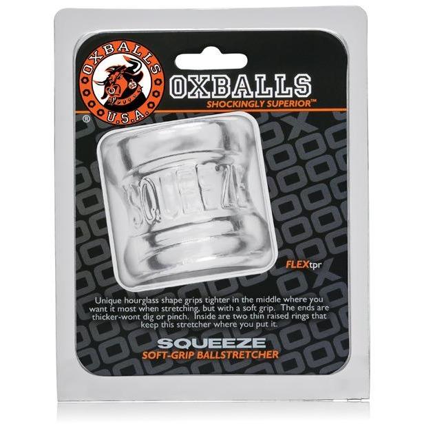 The Oxballs Squeeze Ball Stretcher is presented in clear, hourglass-shaped packaging. It features FlexTPR material and an ergonomic design for comfort, making it a must-have for enthusiasts.
