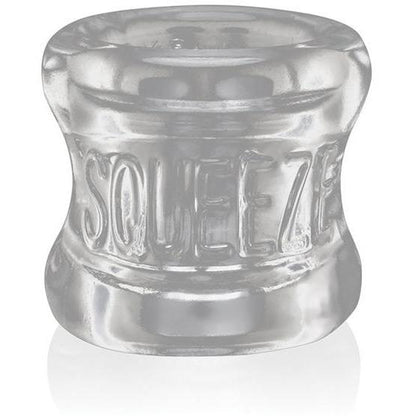 The Oxballs Squeeze Ball Stretcher, by Oxballs, is a clear cylindrical object with SQUEEZE embossed on its glossy surface. Crafted from flexible Flex-TPR material, it offers an ergonomic design for comfort and functionality.
