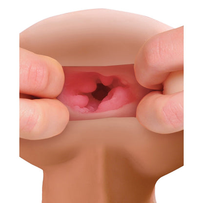 A person holds a realistic model of a human mouth, displaying the intricate textures and colors of the oral cavity. The detailed interior structures resemble those in the PDX Male Reach Around Stroker by PDX, providing an educational insight into human anatomy.