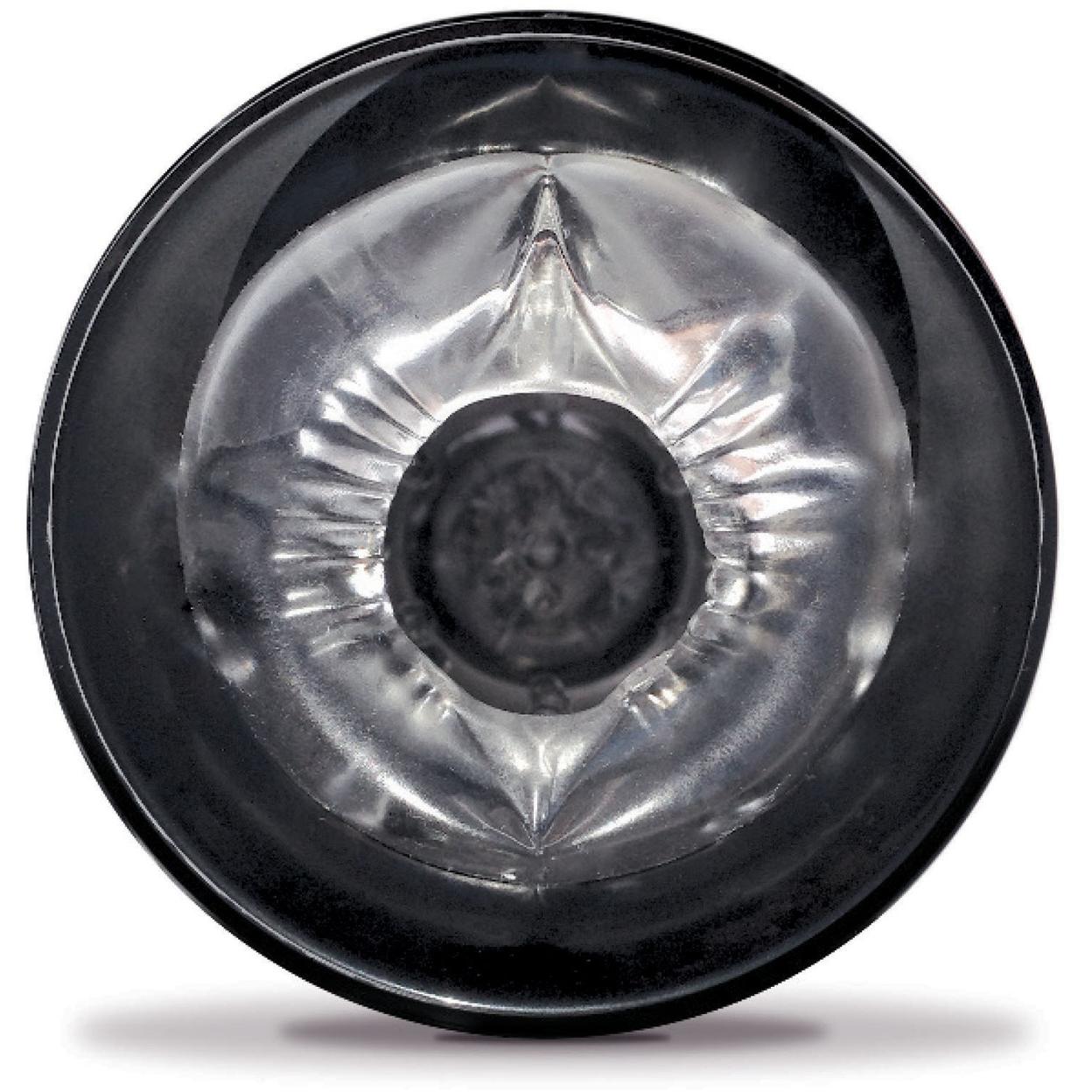 A close-up of the Pipedream Extreme Roto-Bator, a black circular silicone device by Pipedream, showcases its translucent, textured center. The design includes intricate folds and ridges forming a star-like pattern with lighting enhancing the glossy surface akin to delicate pleasure beads.