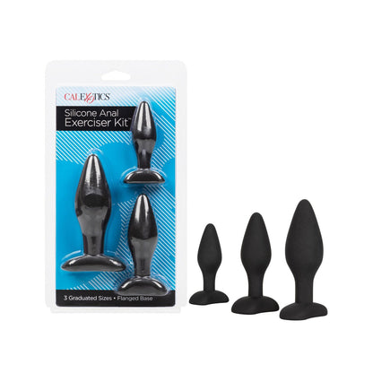 The Silicone Anal Exerciser Kit by California Exotic Novelties includes three black silicone plugs of different sizes, each with a flanged base for comfort. They are phthalate-free and displayed both in their sleek packaging and arranged outside.