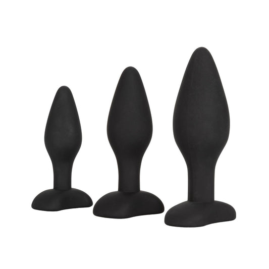 The Silicone Anal Exerciser Kit by California Exotic Novelties showcases three black, phthalate-free silicone exercisers in small, medium, and large sizes, each with flanged bases, aligned on a plain white background.