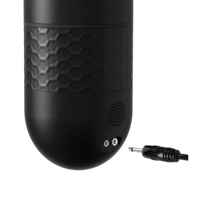 Close-up of a black electronic device with a textured grip and two input ports, showcasing the sleek design of Adams Toy Box Sir Richards Control Power-Bator w/Talking & Moaning. A black audio plug is nearby, enhancing its sophisticated thrusting modes.
