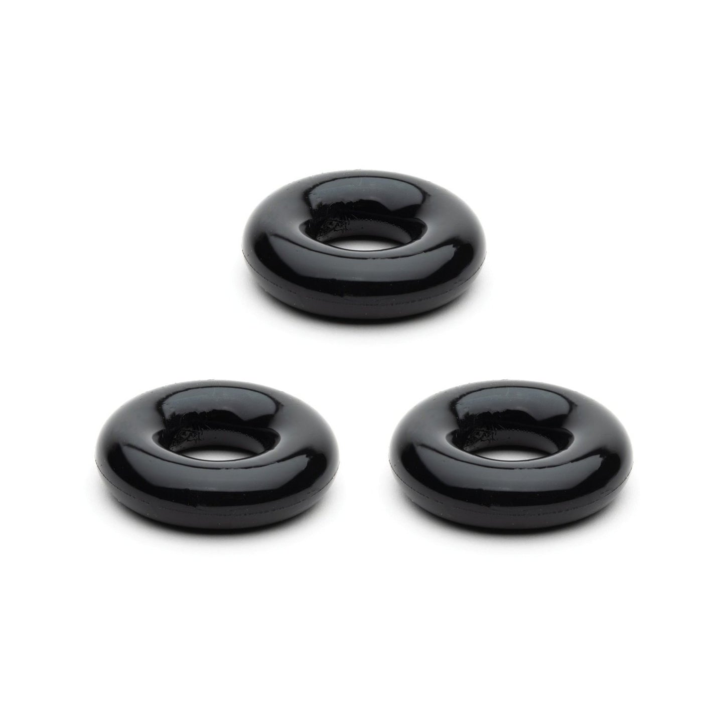 Three sleek, black, round doughnut-shaped objects from the Sport Fucker Chubby Cockring Pack of 3 are evenly spaced on a white background, embodying an enhanced stylish look.