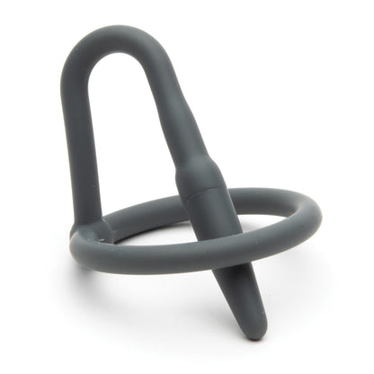 The Sport Fucker Cock Plug by Sport Fucker is a gray cock and ball ring made from medical-grade silicone, featuring an integrated butt plug. The design combines a circular ring with a tapered plug, offering functionality, comfort, and a snug fit for enhanced stimulation.
