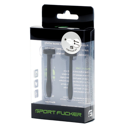 The image displays the packaging for a Sport Fucker Cum Plug Kit, featuring transparent design with black and green text. Inside are two black, medical-grade silicone plug devices.