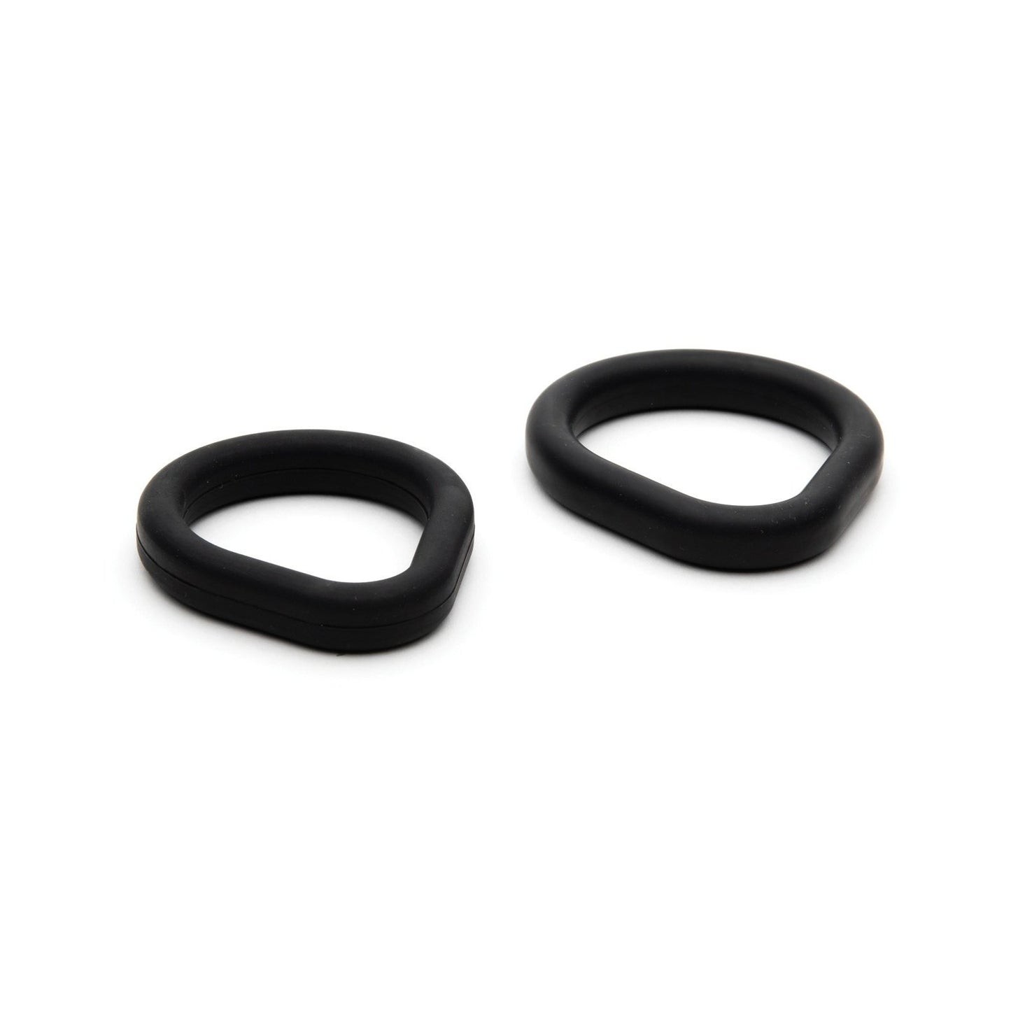 Two black rubber O-rings from the Sport Fucker Epic Hard on Kit by Sport Fucker are displayed on a white background. These silicone rings feature unique oval designs in different sizes, one slightly larger than the other, with smooth textures and rounded edges.