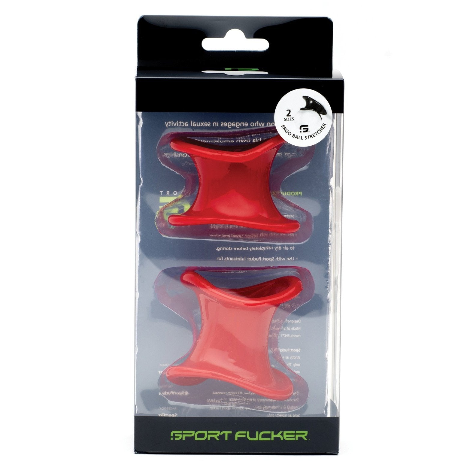 The Sport Fucker Ergonomic Ball Stretcher Kit features two red silicone, hollow cylindrical ball stretchers with wide rims in different sizes. Presented vertically in the clear plastic section of the packaging, it showcases the Sport Fucker branding.