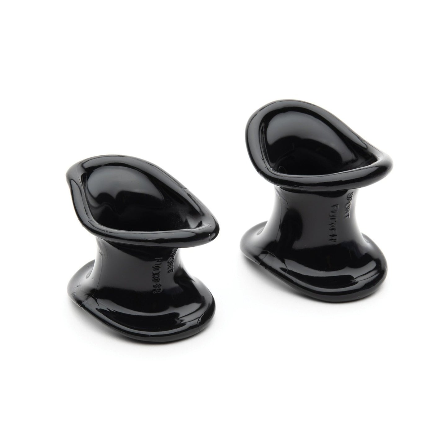 Two black, glossy ergonomic wedges made from a TPR blend, designed to hold doors open. Their sleek, curved form allows for easy placement and removal under a door. Product: Ergonomic Ball Stretcher Kit by Sport Fucker.