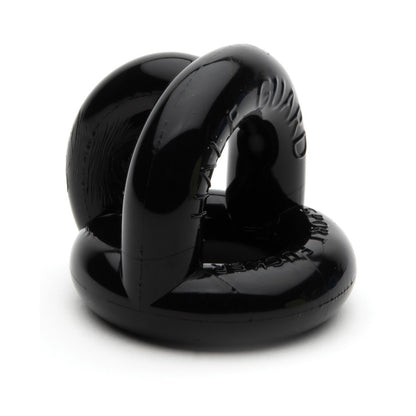 The Sport Fucker Half Guard by Sport Fucker is a black circular object with hollow sections and embossed text, made from shiny Flex TPR material. Its interlocking design has smooth edges with two curved parts connected together, resembling a super stretchy cock ring.