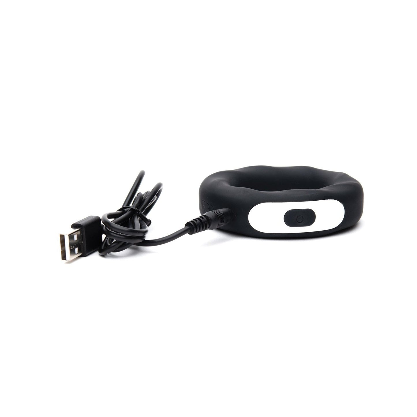 The Sport Fucker Motovibe Rev Cockring by Sport Fucker is a stylish black circular device made of medical-grade silicone, featuring a white oval button with a power symbol. It comes with a USB rechargeable cable, combining functionality and modern elegance in one package.